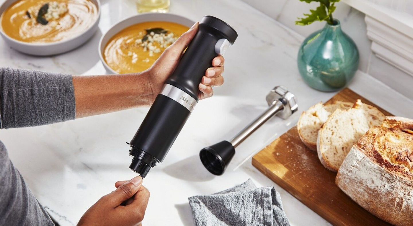 Person taking apart black KitchenAid® immersion blender
