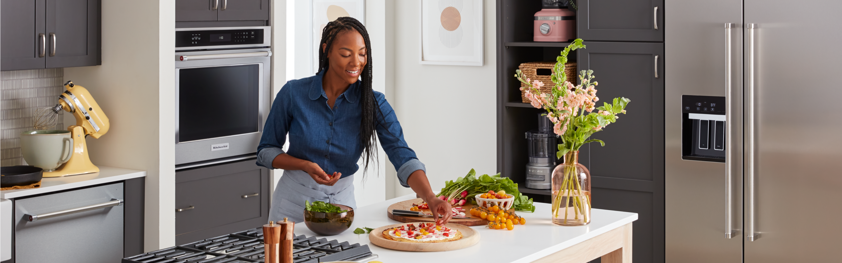 A person cooking multiple dishes on a cooktop.