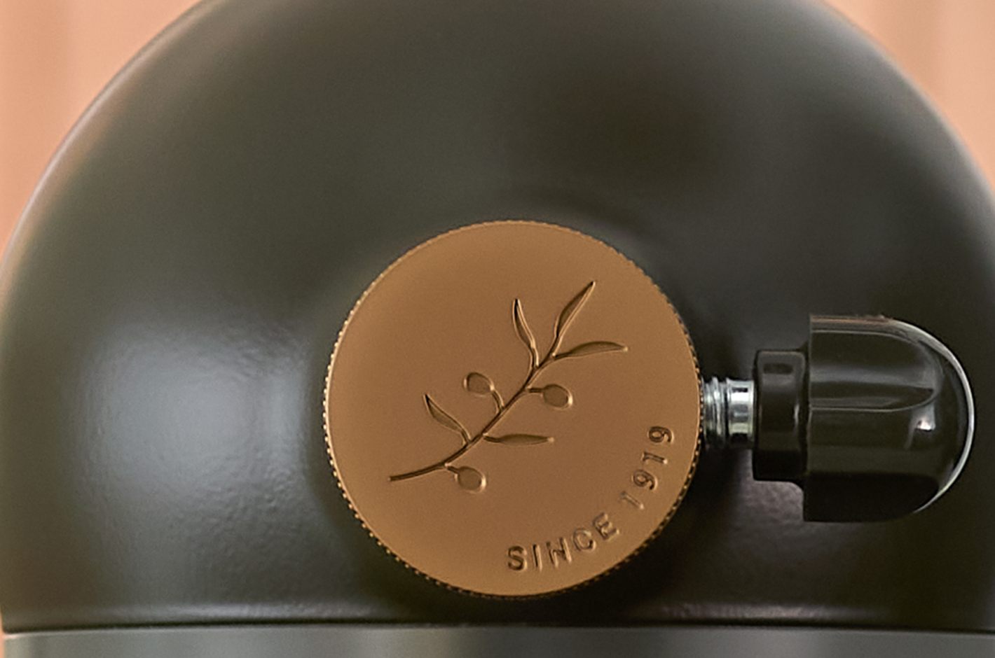 The brass-plated hub cover with a debossed leaf motif.
