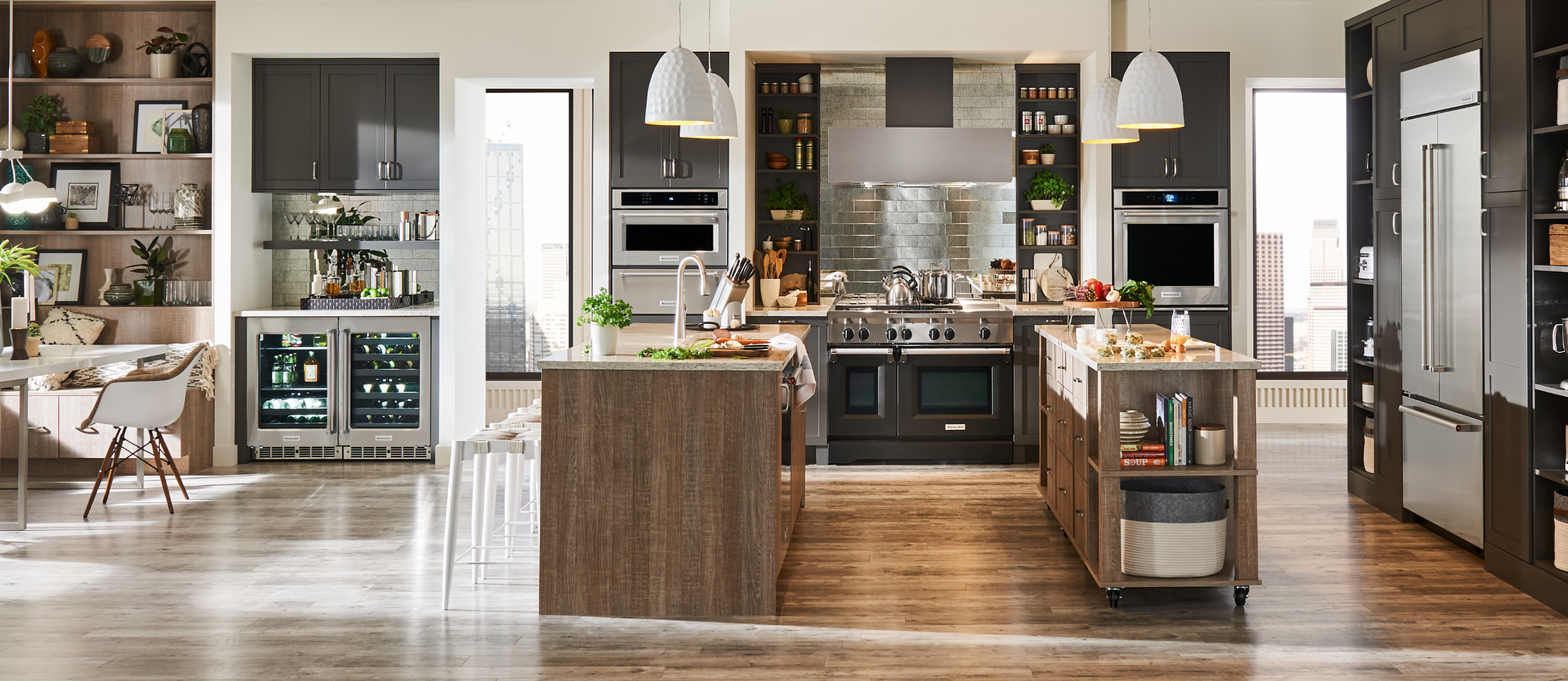 A large modern kitchen with a double island and a suite of built-in appliances. 