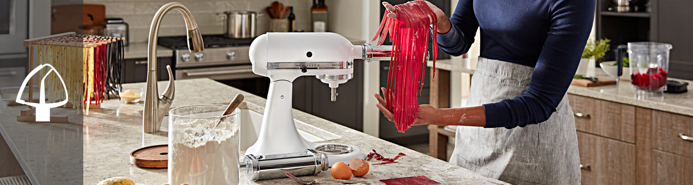 Person using a KitchenAid® pasta attachment
