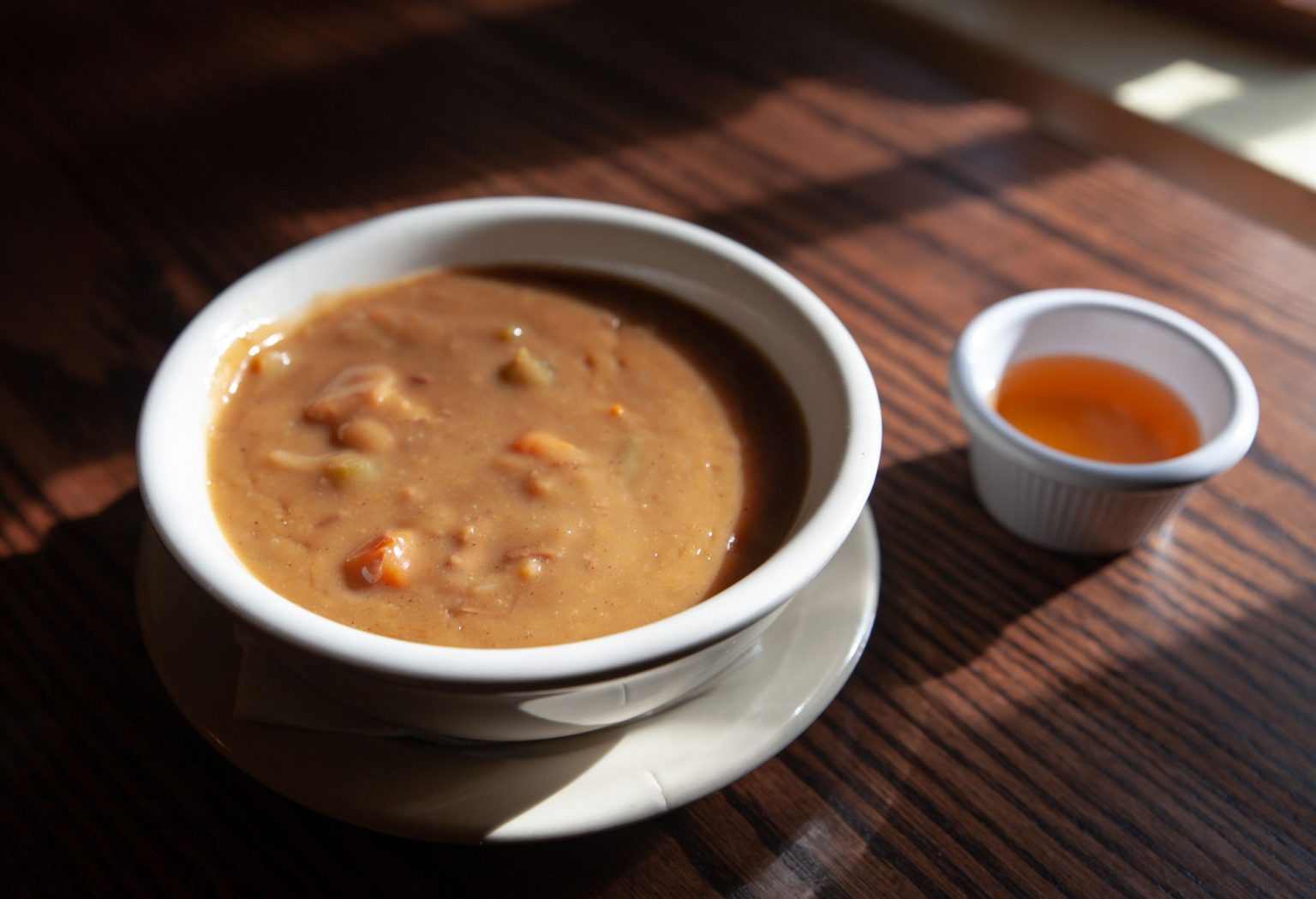 A small, white bowl of creamy snapper soup.