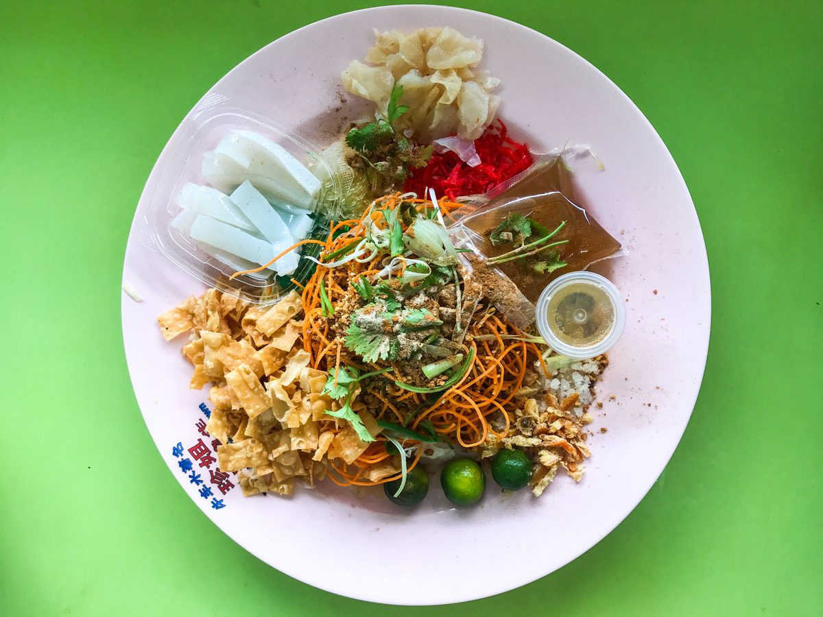 Raw fish salad served with different sauces and garnishes.