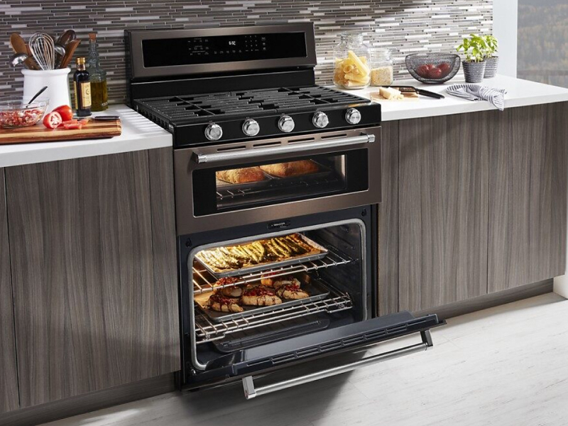 Various dishes cooking in a gas oven range