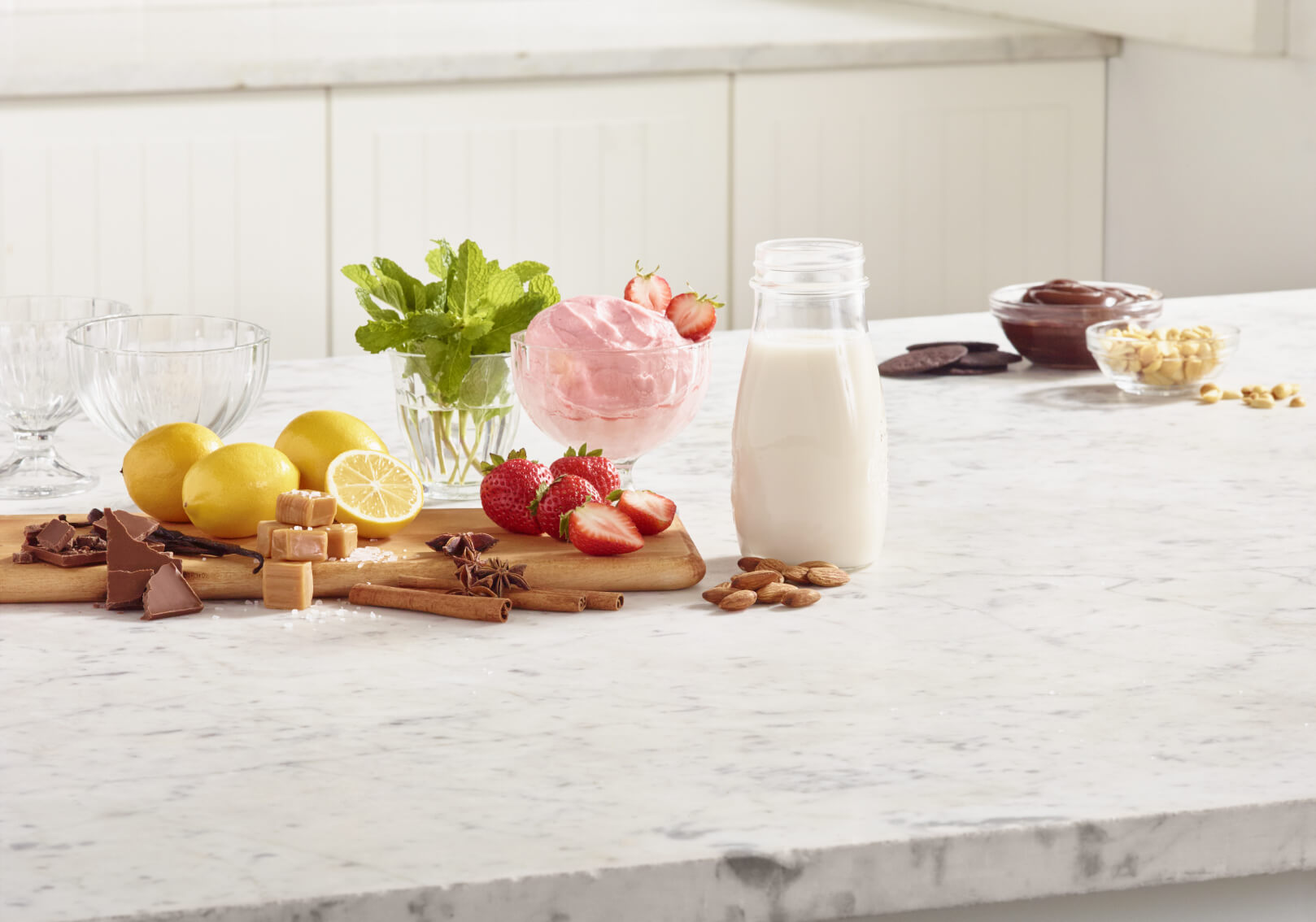 Ingredients and toppings for making frozen yogurt at home.