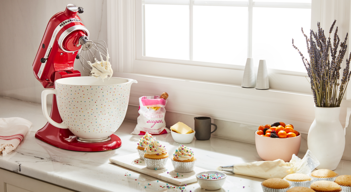 KitchenAid® Stand Mixer with a decorative bowl mixing frosting