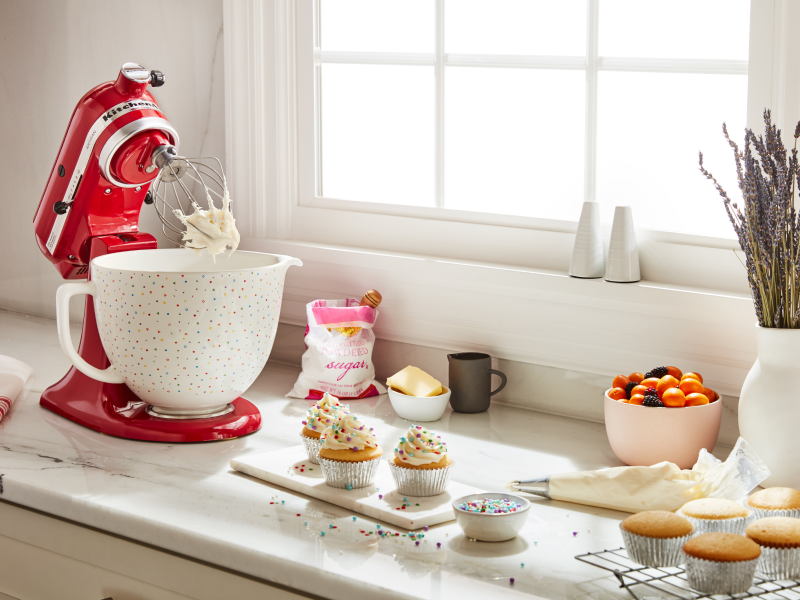 KitchenAid® Stand Mixer with a decorative bowl mixing frosting