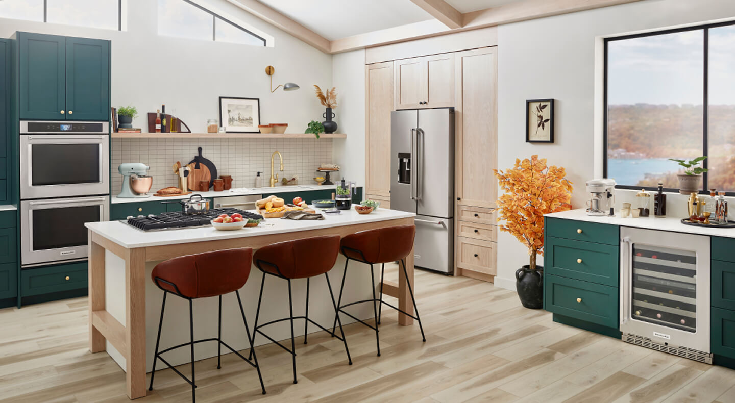 A trendy, stylish kitchen with teal cabinetry and a suite of KitchenAid® appliances