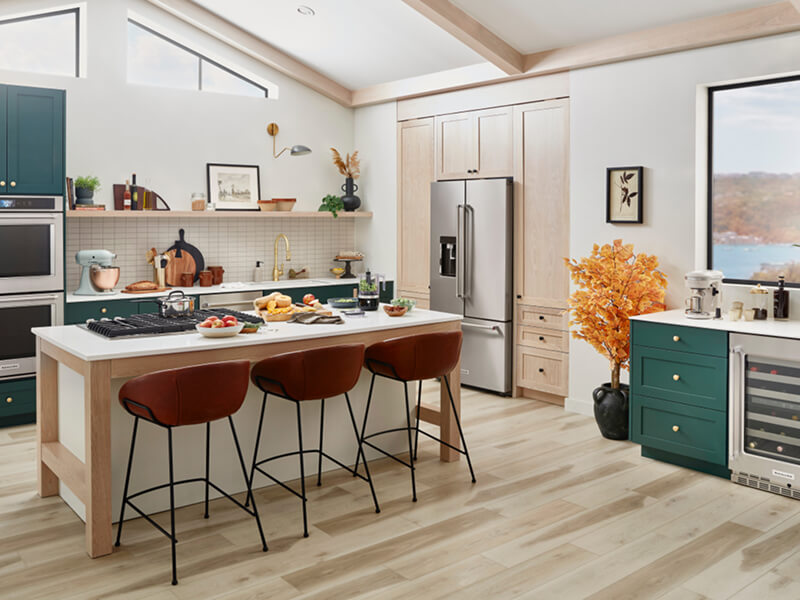 A trendy, stylish kitchen with teal cabinetry and a suite of KitchenAid® appliances