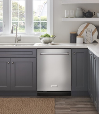 A built-in KitchenAid® dishwasher in a kitchen with gray cabinets