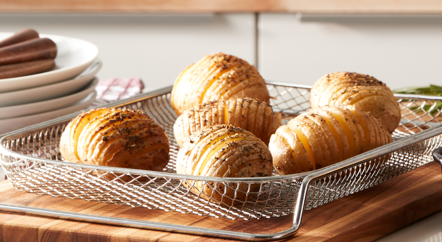 Hasselback potatoes on wire mesh tray 