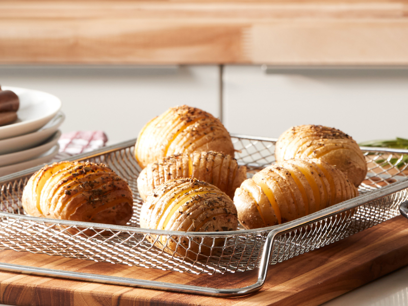 Hasselback potatoes on wire mesh tray 