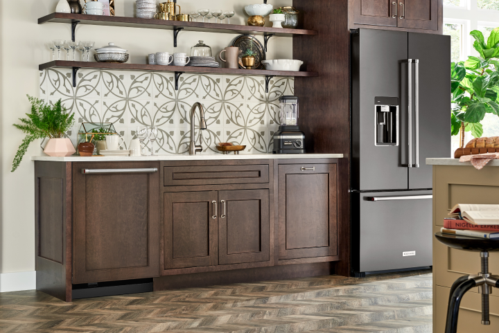 A KitchenAid® refrigerator with a sleek black finish in a modern kitchen