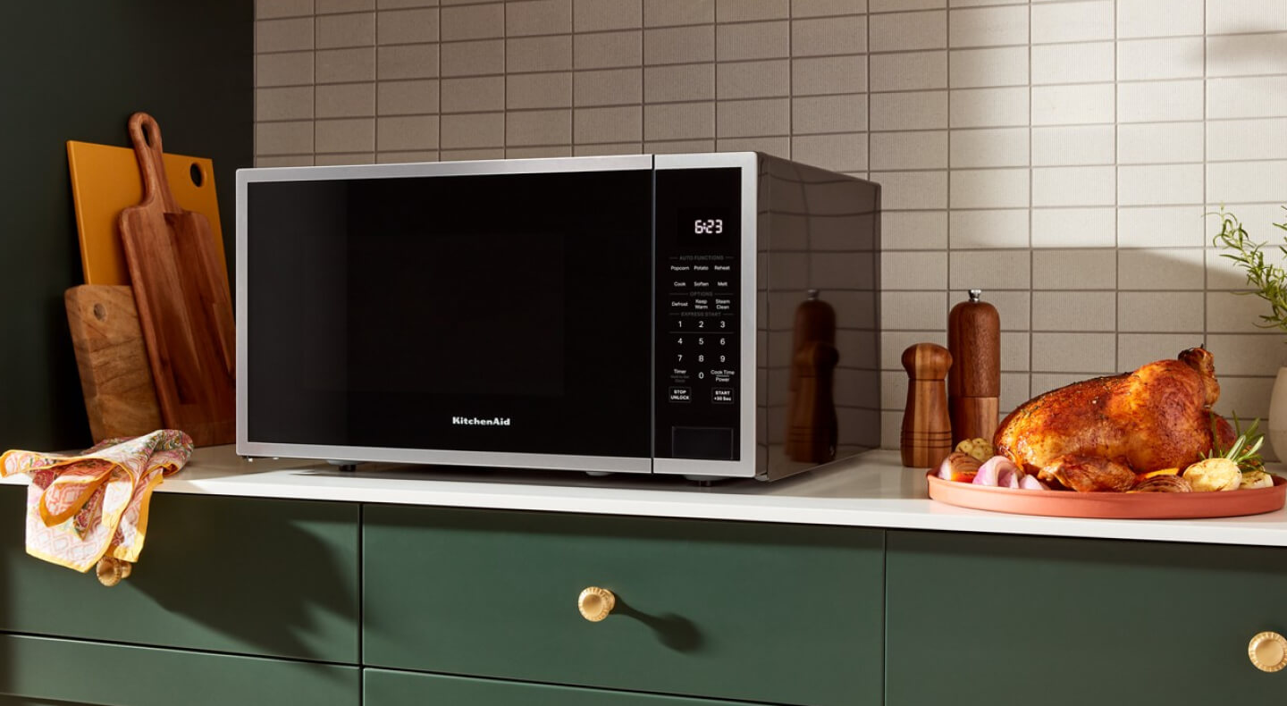 KitchenAid® countertop microwave next to roasted chicken