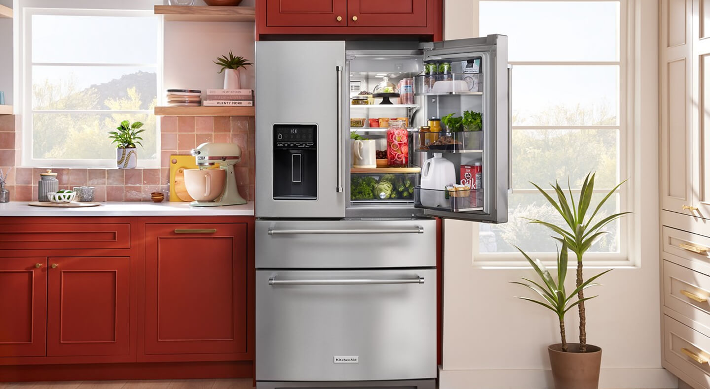 Open stainless steel KitchenAid® four door refrigerator with fresh food inside