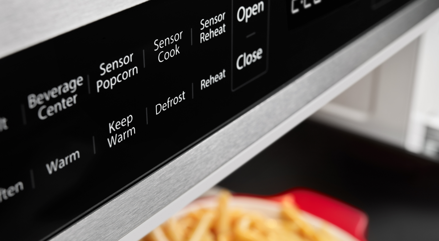 A close up of microwave controls