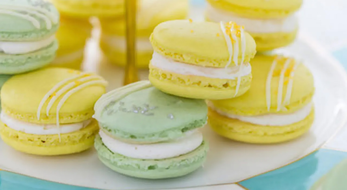 A plate of lemon and lime macarons.