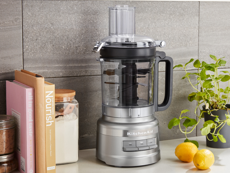 A KitchenAid® food processor on a modern kitchen counter.