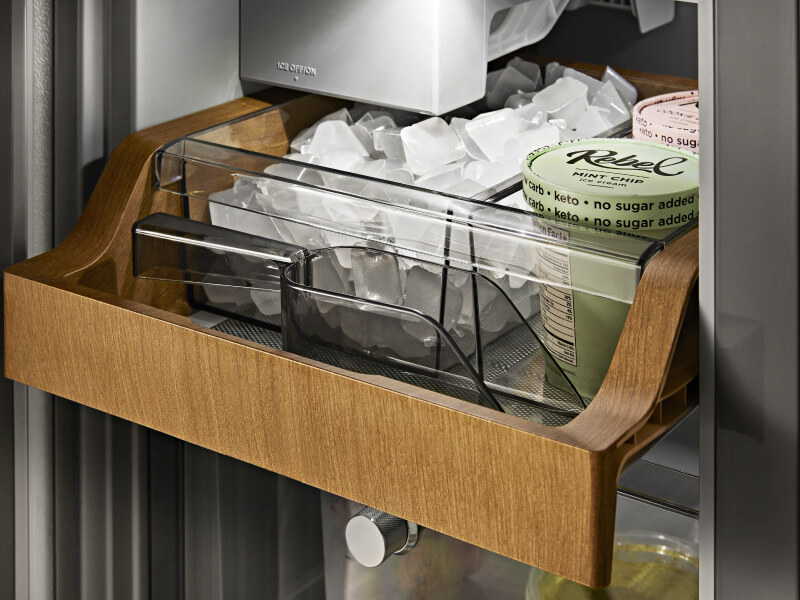 Ice and ice cream inside a wood-paneled ice compartment