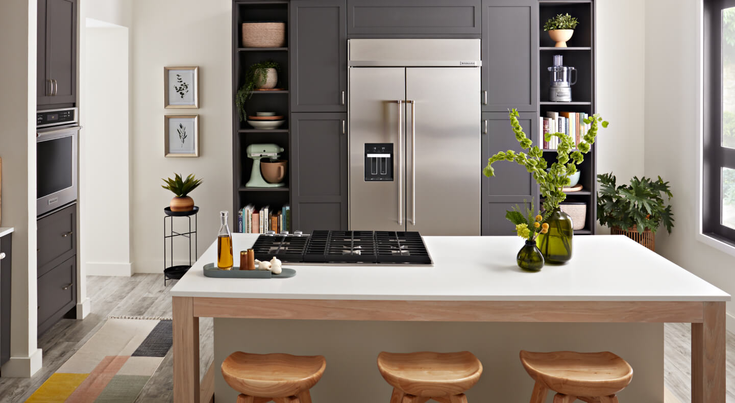 Kitchen island in front of built-in refrigerator