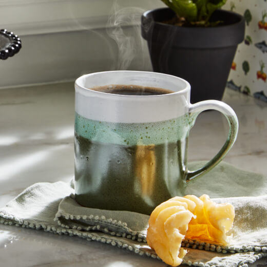 Black coffee and a half eaten donut