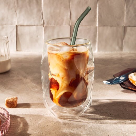 Iced coffee in a glass with a reusable straw