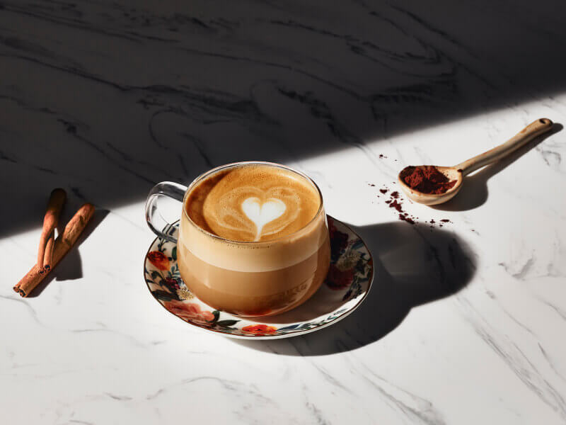 Latte with a steamed milk heart in a glass mug