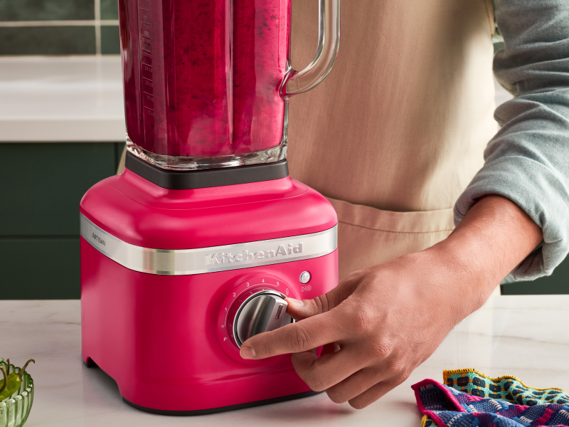 A person programming a blender setting on a KitchenAid® blender.