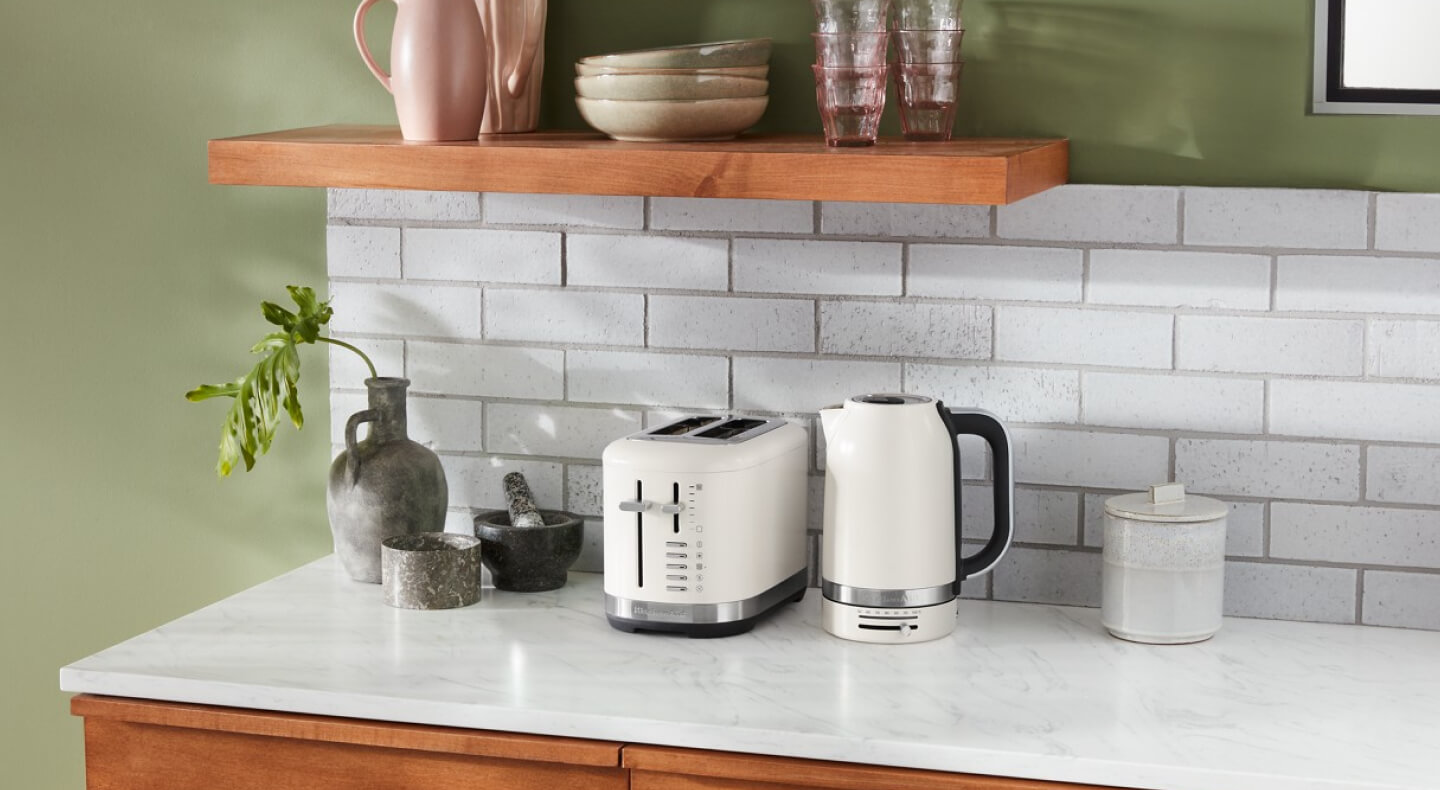 Off white KitchenAid® toaster and kettle on a countertop