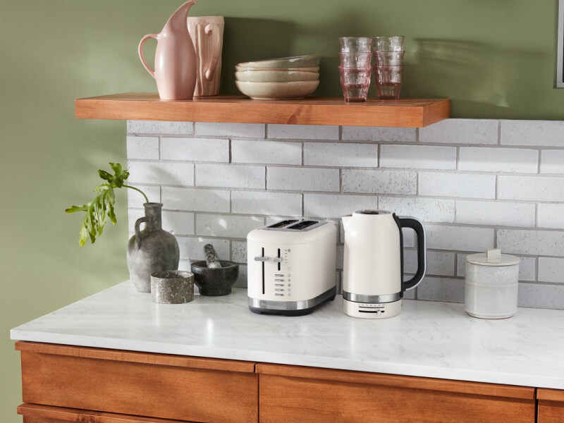 Off white KitchenAid® toaster and kettle on a countertop