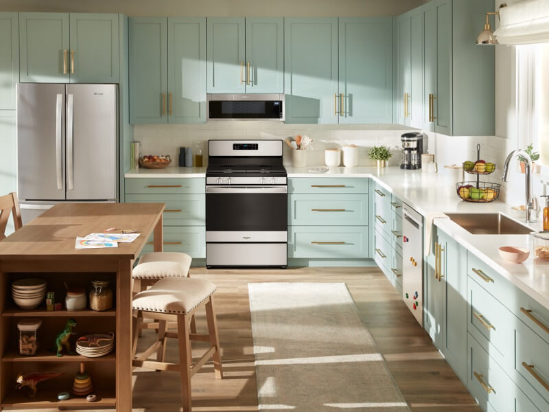 Light blue and white kitchen with stainless steel appliances