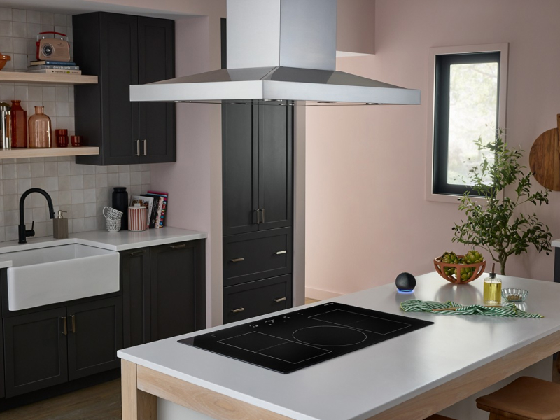 Kitchen island with an electric cooktop and canopy vent hood