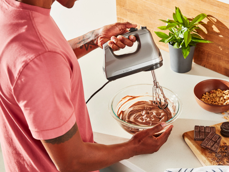 Person using hand mixer with Flex Edge Beaters
