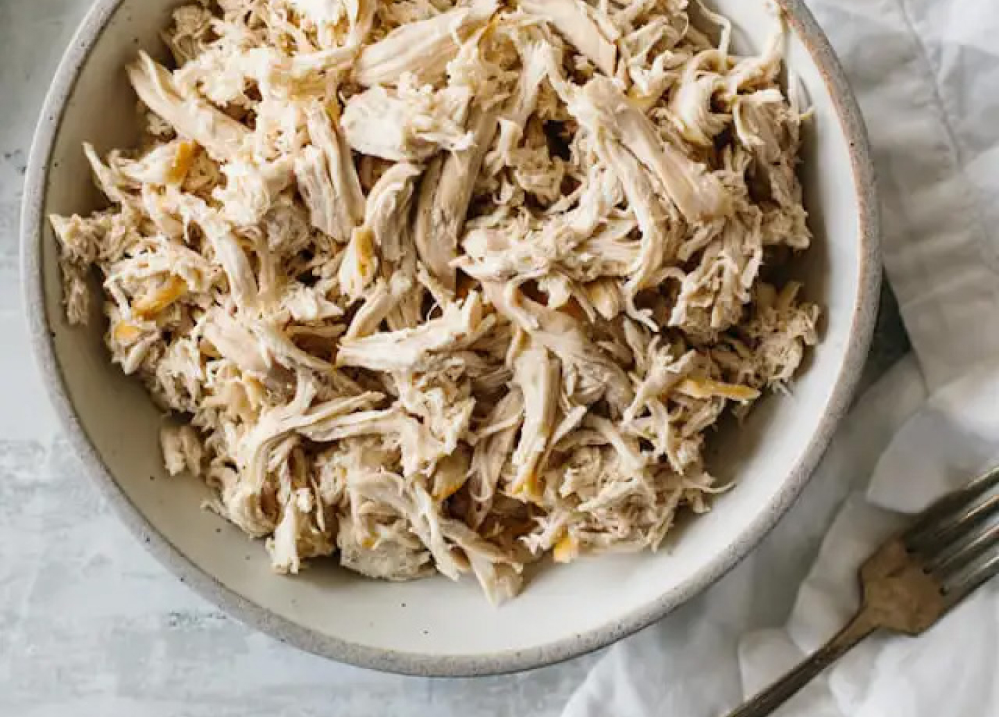 A bowl of shredded chicken.