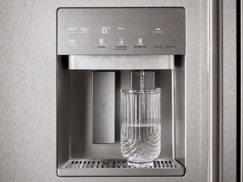 Water filling a glass from a dispenser automatically