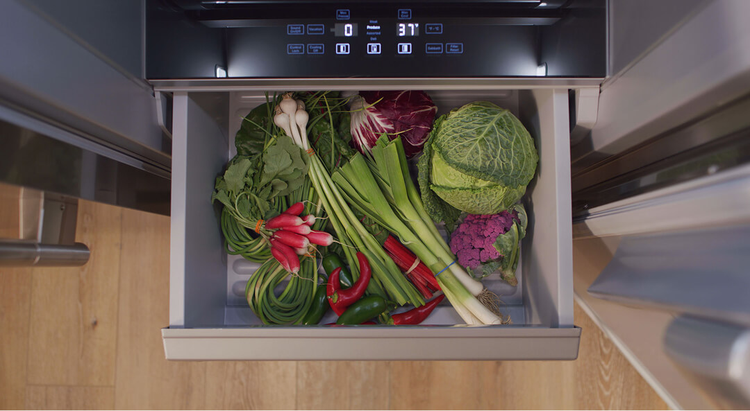 Bird’s-eye view of fresh vegetables in a pull-out refrigerator drawer