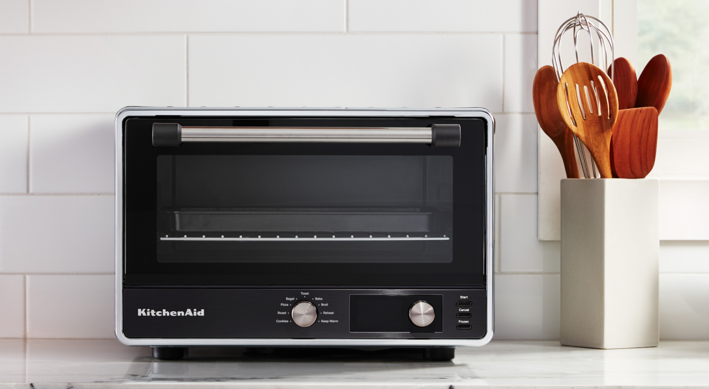 A KitchenAid® countertop oven with air fry on a modern kitchen counter. 