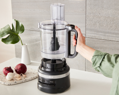 A work bowl being attached to a food processor base