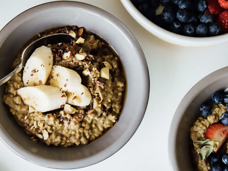 Homemade oatmeal with various fruit toppings and chopped nuts