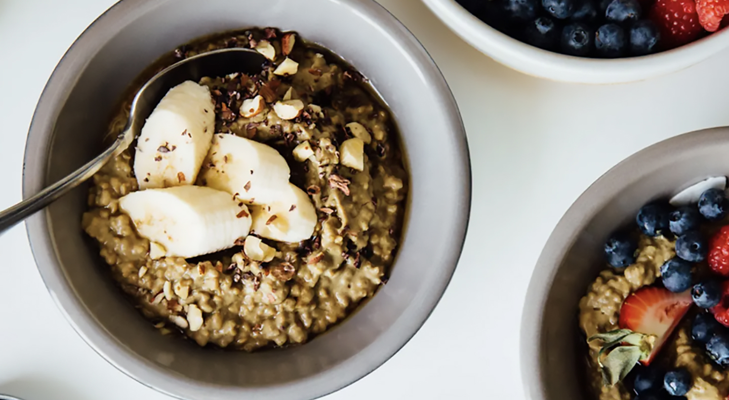 Homemade oatmeal with various fruit toppings and chopped nuts