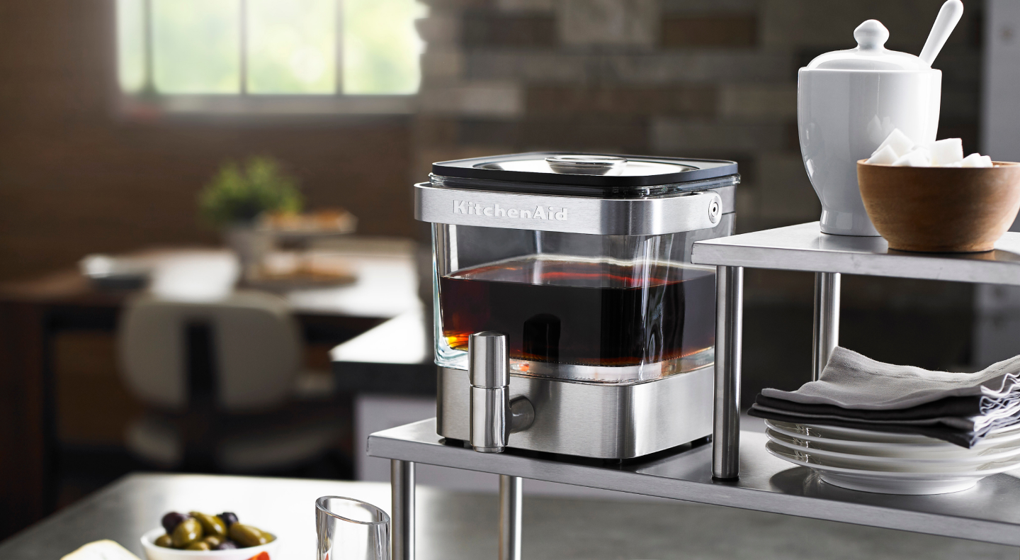 Full cold brew coffee maker near bowl of sugar cubes