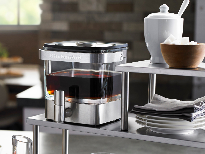 Full cold brew coffee maker near bowl of sugar cubes