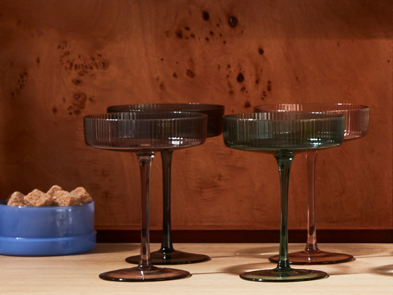 Dark colored martini glasses on a counter top