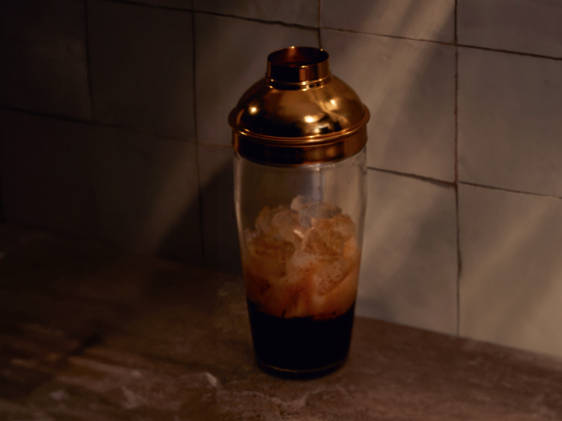 Espresso martini ingredients in a glass cocktail shaker