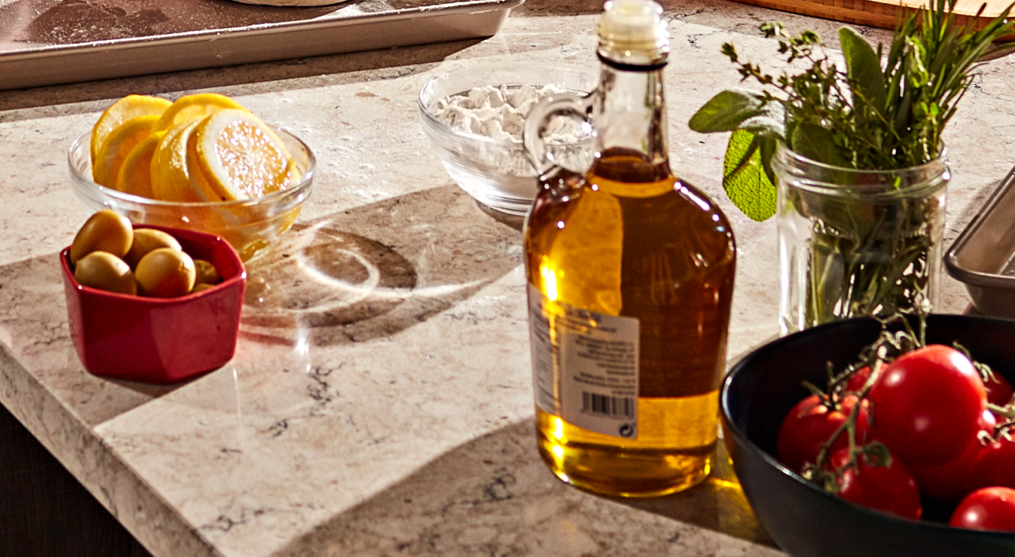 Sliced lemons, cherry tomatoes, herbs and a jar of vinaigrette.