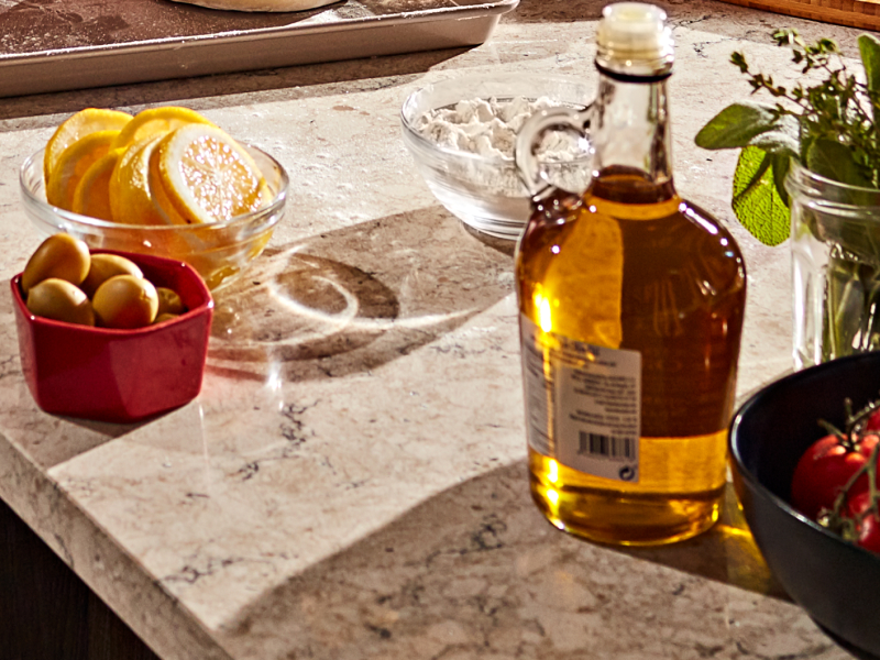 Sliced lemons, cherry tomatoes, herbs and a jar of vinaigrette.