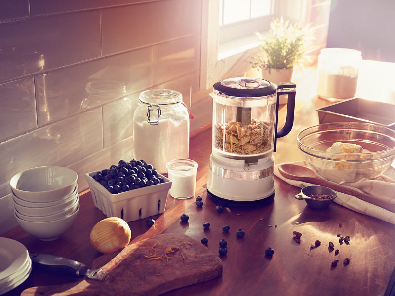 KitchenAid® food chopper on countertop with blueberries and cream cheese