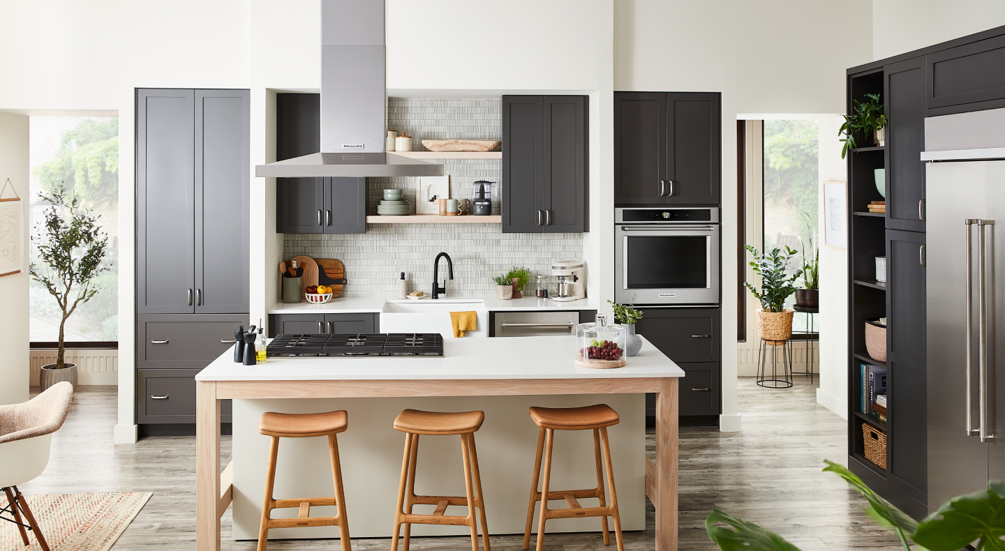 Kitchen with gray cabinets and island with cooktop