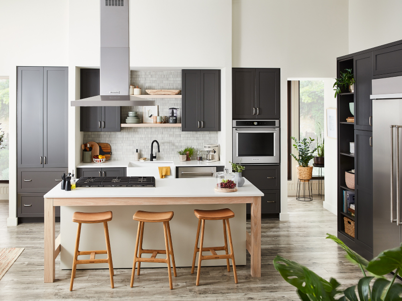 Kitchen with gray cabinets and island with cooktop