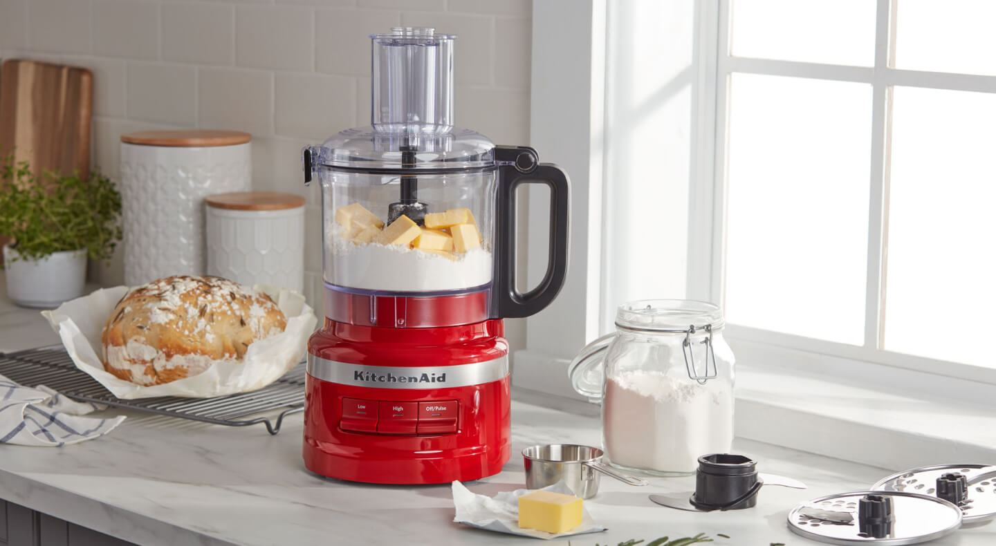 KitchenAid® food processor with bread ingredients on countertop